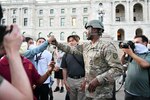 Master Sgt. Acie Matthews of the Minnesota National Guard engaged with protesters to show solidarity and request they comply with the state curfew at the grounds of the Minnesota State Capitol in St. Paul June 1, 2020.