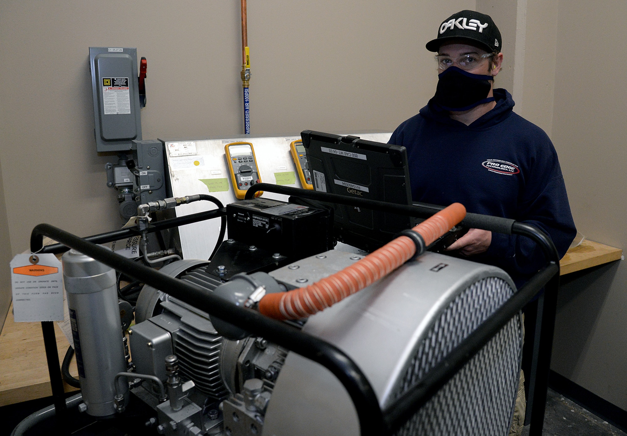 Skylar Cleveland, 581 Missile Maintenance Squadron powered support system mechanic, checks test results while performing a 4-hour run test during periodic depot maintenance on a shock isolator air compressor on Apr. 28, 2020, at Hill Air Force Base, Utah.