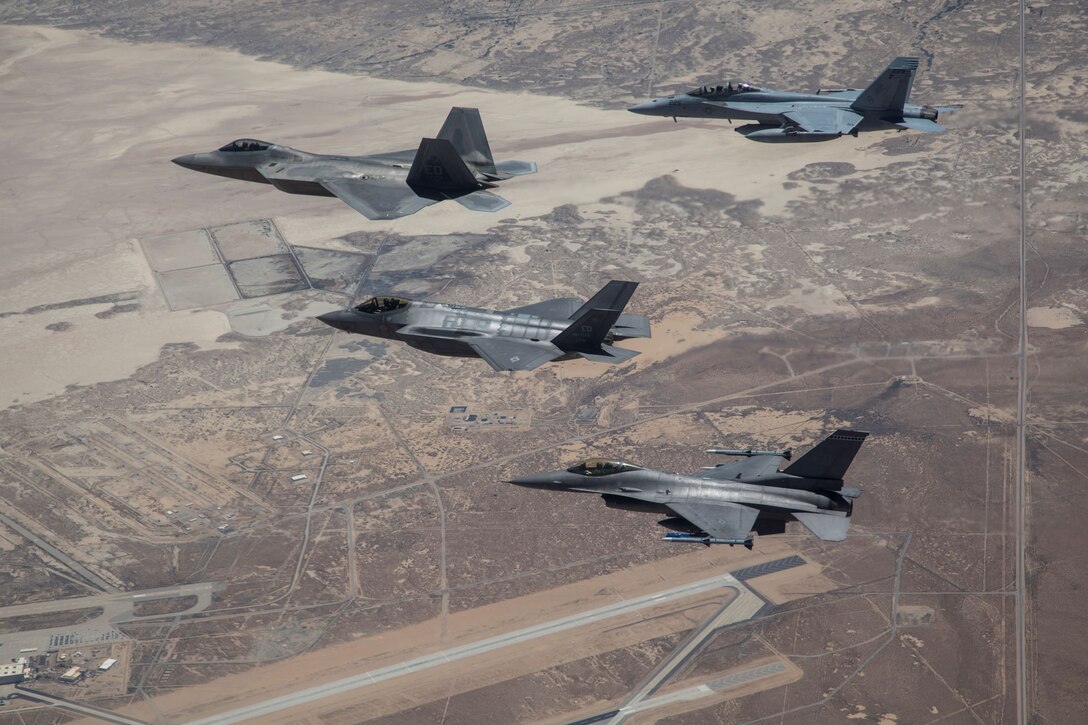 Various aircraft participating in Orange Flag Exercise (OFE) fly over Edwards Air Force Base, California,  during OFE 19-2.  COVID-19 telework operations have created new opportunities for engineers from the 412th Test Wing teams to spend more time on software development environments to support weapons analysis, and to support multi-platform multi-service analysis for large force exercises such as OFE.