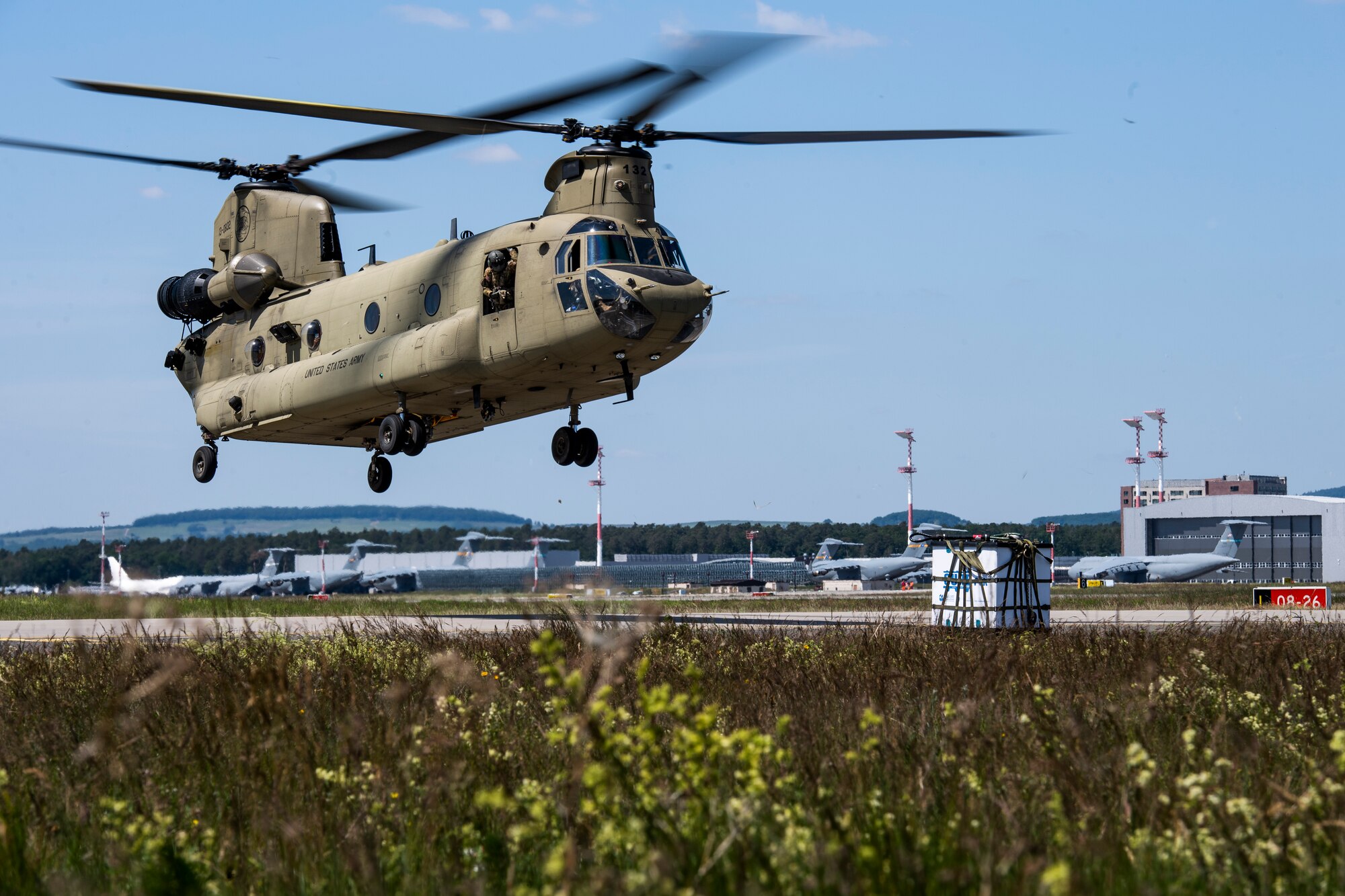 Photo of CH-47 Chinook hovering over airfield