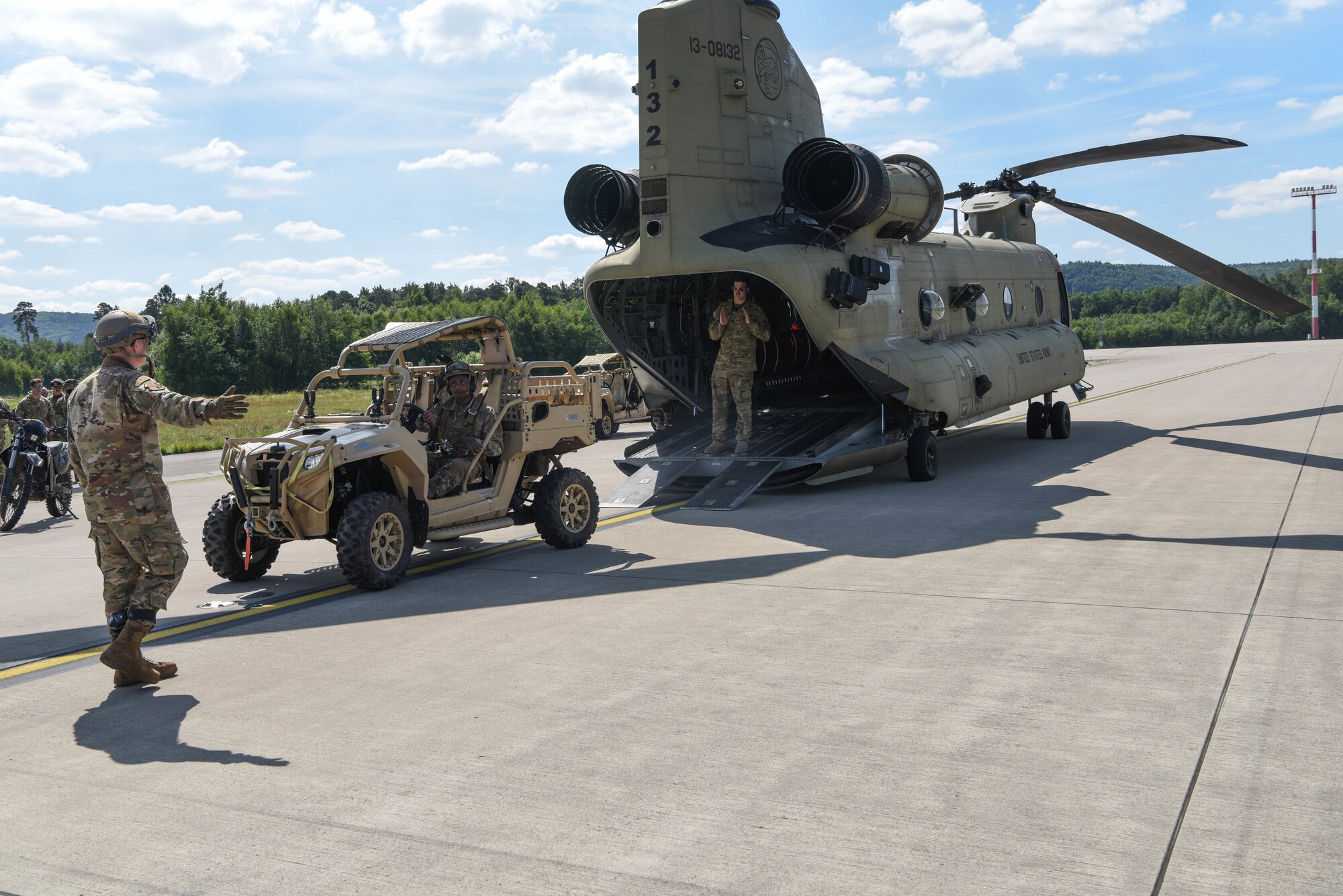 U.S. Air Force Senior Airman Marcus Moore, 435th Contingency Response Squadron mobile aerial port journeyman, drives an MRZR all-terrain vehicle onto a CH-47 Chinook helicopter during exercise Agile Wolf 20-04.