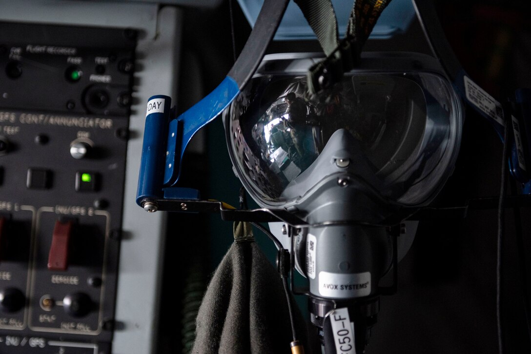 An oxygen mask hangs in the cockpit of a U.S. KC-135 Stratotanker assigned to 22nd Expeditionary Air Refueling Squadron during a training flight over the Black Sea May 29, 2020. Training outside the U.S. enables aircrew and Airmen to become familiar with other theaters and airspace, and enhances enduring skills and relationships necessary to confront a broad range of global challenges in support of the National Defense Strategy. (U.S. Air Force photo by Staff Sgt. Joshua Magbanua)