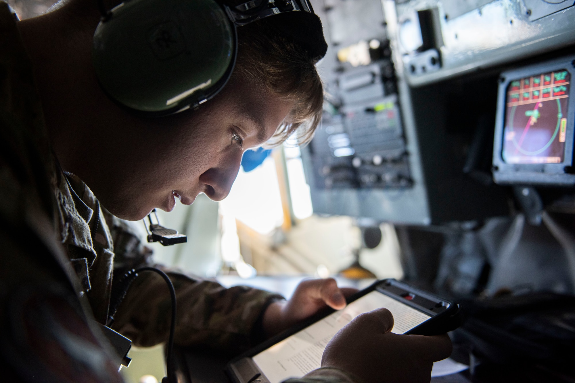 U.S. Air Force Airman 1st Class Austin Buller, 22nd Expeditionary Air Refueling Squadron boom operator, reads technical instructions during a training flight over the Black Sea May 29, 2020. Participation in multinational exercises enhances our professional relationships and improves overall coordination with allies and partner militaries during times of crisis. (U.S. Air Force photo by Staff Sgt. Joshua Magbanua)