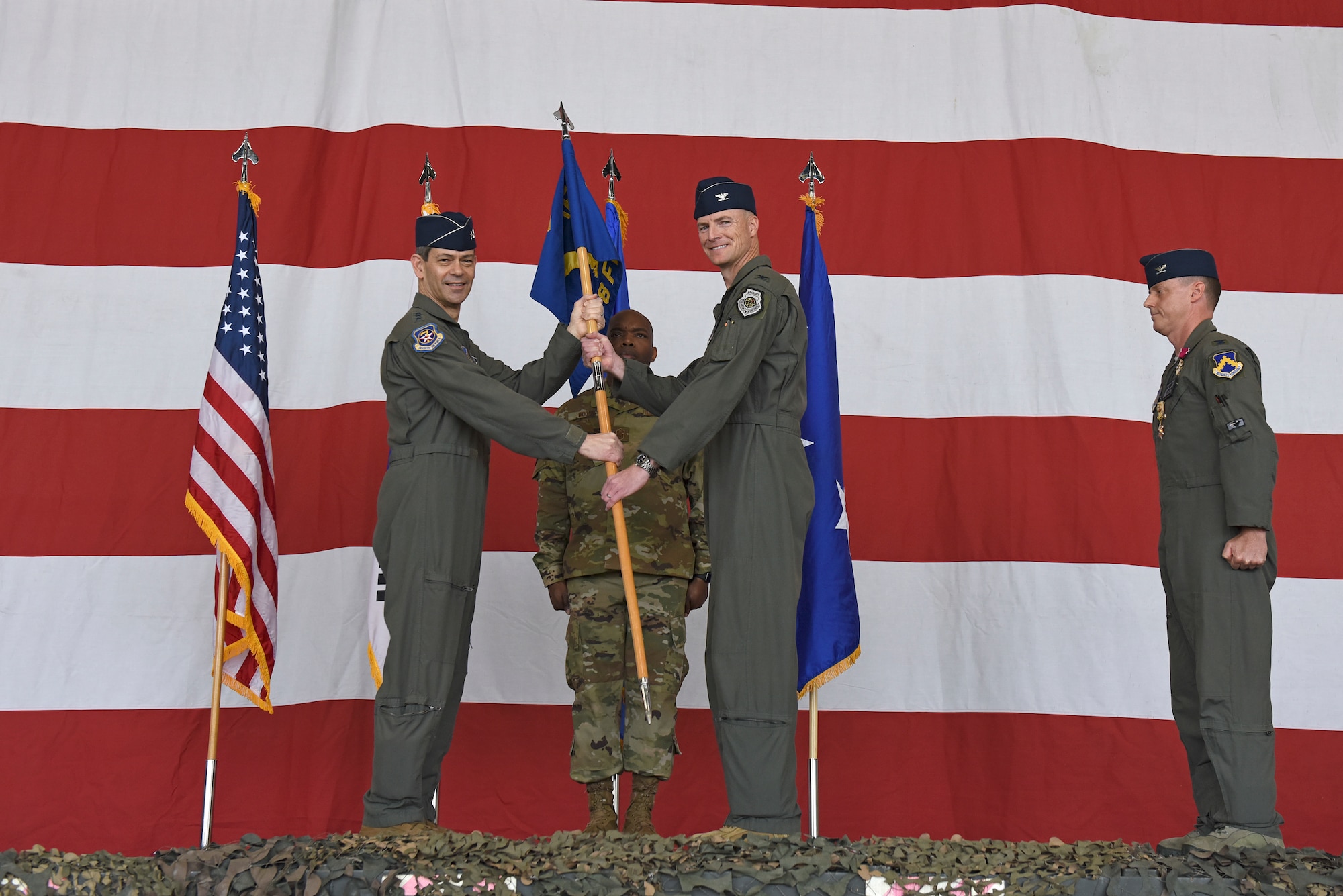 Col. Christopher Hammond, 8th Fighter Wing commander, accepts the guidon from Lt. Gen. Ken Wilsbach, 7th Air Force commander, during the 8th FW change of command ceremony at Kunsan Air Base, Republic of Korea, June 2, 2020. As Wolf 60, Hammond is responsible for more than 2,700 active-duty personnel, four groups and 13 squadrons, including two F-16 squadrons tasked with supporting 7th Air Force operational readiness. (U.S. Air Force photo by Staff Sgt. Mackenzie Mendez)