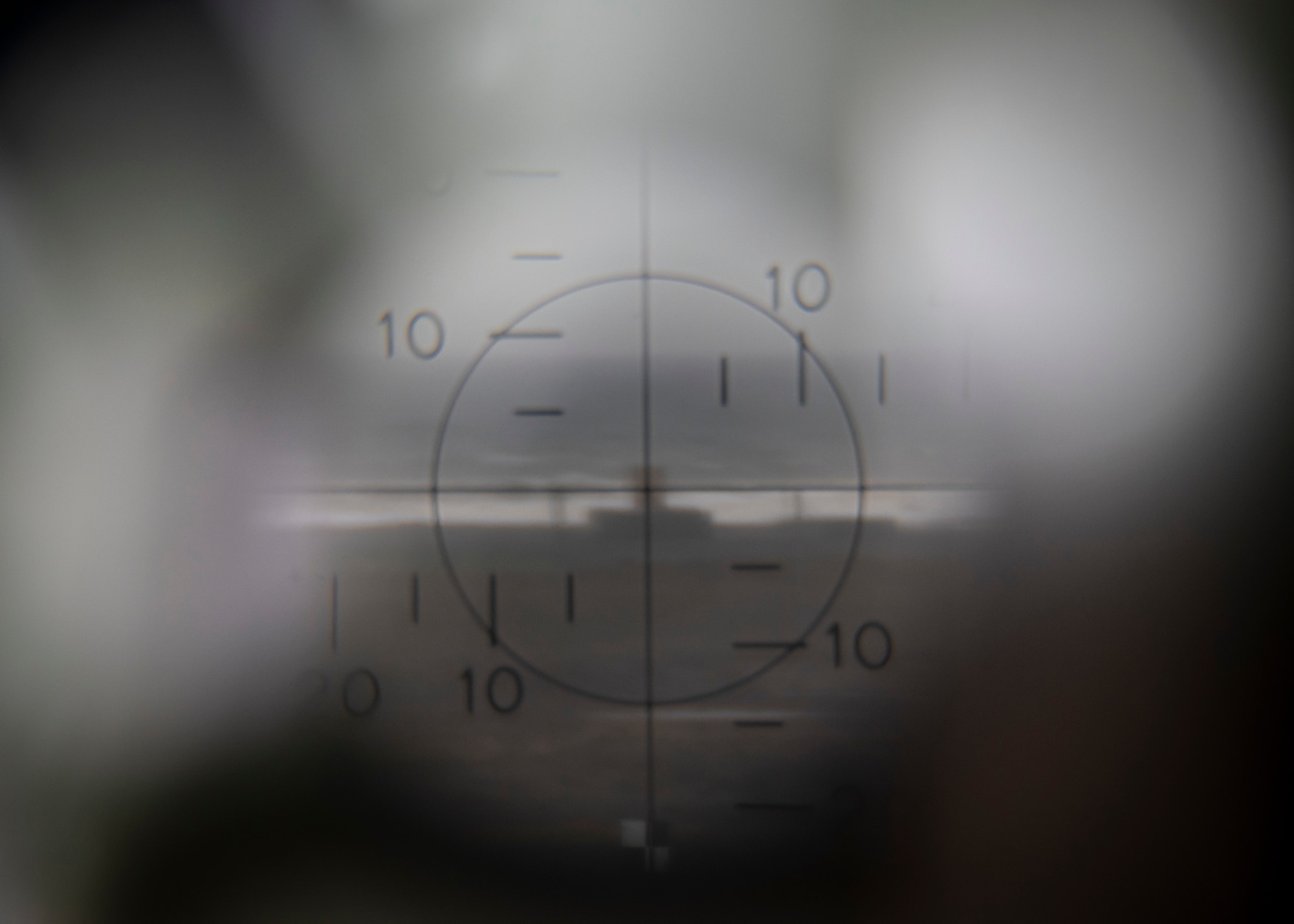 The view inside a M2A2 aiming scope at Draughon Range near Misawa Air Base, Japan, May 20, 2020. The image depicts the F-16 Fighting Falcon’s impact point when dropping inert munitions. This premier range allows military forces to safely employ inert munitions, enhancing the readiness of Misawa’s F-16 Fight Falcon pilots and other U.S. personnel to maintain the defense of Japan. Draughon Range provides realistic training for pilots by simulating enemy detection and attacks with threat emitters. (U.S. Air Force photo by Airman 1st Class China M. Shock)
