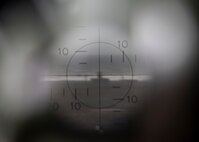 The view inside a M2A2 aiming scope at Draughon Range near Misawa Air Base, Japan, May 20, 2020. The image depicts the F-16 Fighting Falcon’s impact point when dropping inert munitions. This premier range allows military forces to safely employ inert munitions, enhancing the readiness of Misawa’s F-16 Fight Falcon pilots and other U.S. personnel to maintain the defense of Japan. Draughon Range provides realistic training for pilots by simulating enemy detection and attacks with threat emitters. (U.S. Air Force photo by Airman 1st Class China M. Shock)