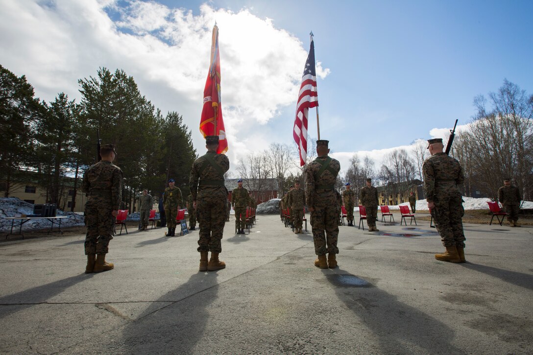 U.S. Marines and Norwegian Soldiers stand at attention