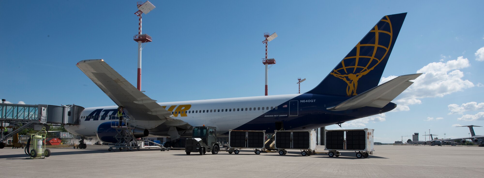 A picture of a vehicle parking next to an aircraft.