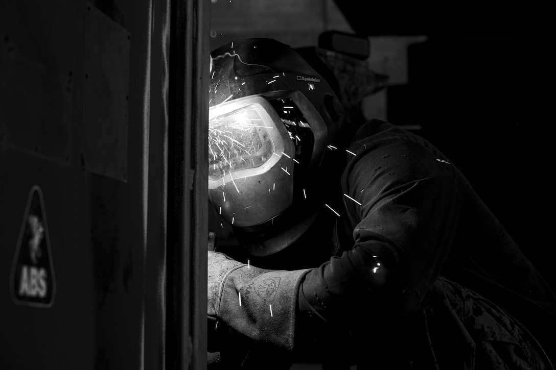 A U.S. Marine welds a Quadcon on Camp Kinser, Okinawa, Japan, May 19.