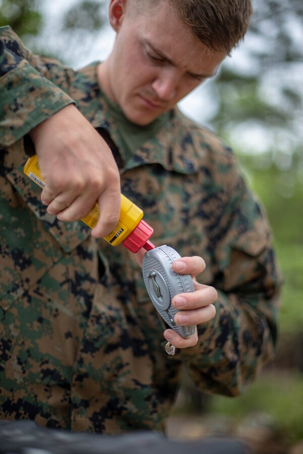 Lance Cpl. Tyler Alexander, a combat engineer with Special Purpose Marine Air-Ground Task Force - Southern Command, refills chalk line during a general exercise at Marine Corps Base Camp Lejeune, North Carolina, April 13, 2020. The GENEX includes training events such as engineering projects and evacuation control center training scenarios that will help build the SPMAGTF-SC for their final certification exercise. These training events also provide the Marines and Sailors with real-world scenarios to prepare them for their deployment to assist partner nation militaries in Latin America and the Caribbean. Alexander is a native of Scappoose, Oregon. (U.S. Marine Corps photo by Cpl. Benjamin D. Larsen)
