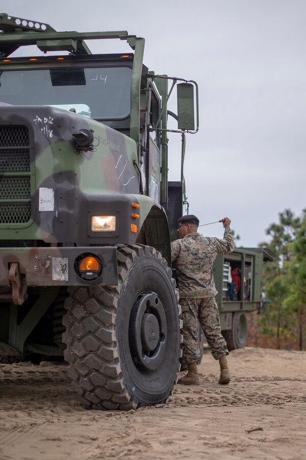 Cpl. Carlos Vasquez, a heavy equipment operator with Special Purpose Marine Air-Ground Task Force - Southern Command, conducts morning maintenance inspection during a general exercise at Marine Corps Base Camp Lejeune, North Carolina, April 13, 2020. Daily equipment inspections are essential to the life and dependability of machinery. The GENEX includes training events such as engineering projects and evacuation control center training scenarios that will help build the SPMAGTF-SC for their final certification exercise. These training events also provide the Marines and Sailors with real-world scenarios to prepare them for their deployment to assist partner nation militaries in Latin America and the Caribbean. Vasquez is a native of Stockton, California. (U.S. Marine Corps photo by Cpl. Benjamin D. Larsen)
