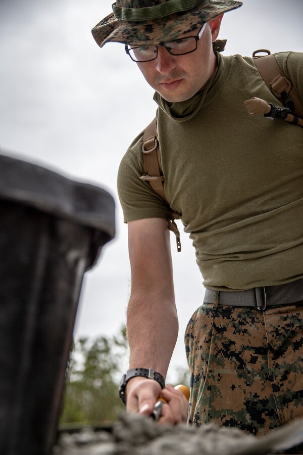 Cpl. Talon Malone, a combat engineer with Special Purpose Marine Air-Ground Task Force - Southern Command, prepares a mixture of mortar during a general exercise at Marine Corps Base Camp Lejeune, North Carolina, April 13, 2020. The Marines used mortar to create a solid base to begin construction of a building. The GENEX includes training events such as engineering projects and evacuation control center training scenarios that will help build the SPMAGTF-SC for their final certification exercise. These training events also provide the Marines and Sailors with real-world scenarios to prepare them for their deployment to assist partner nation militaries in Latin America and the Caribbean. Malone is a native of Estacada, Oregon. (U.S. Marine Corps photo by Cpl. Benjamin D. Larsen)