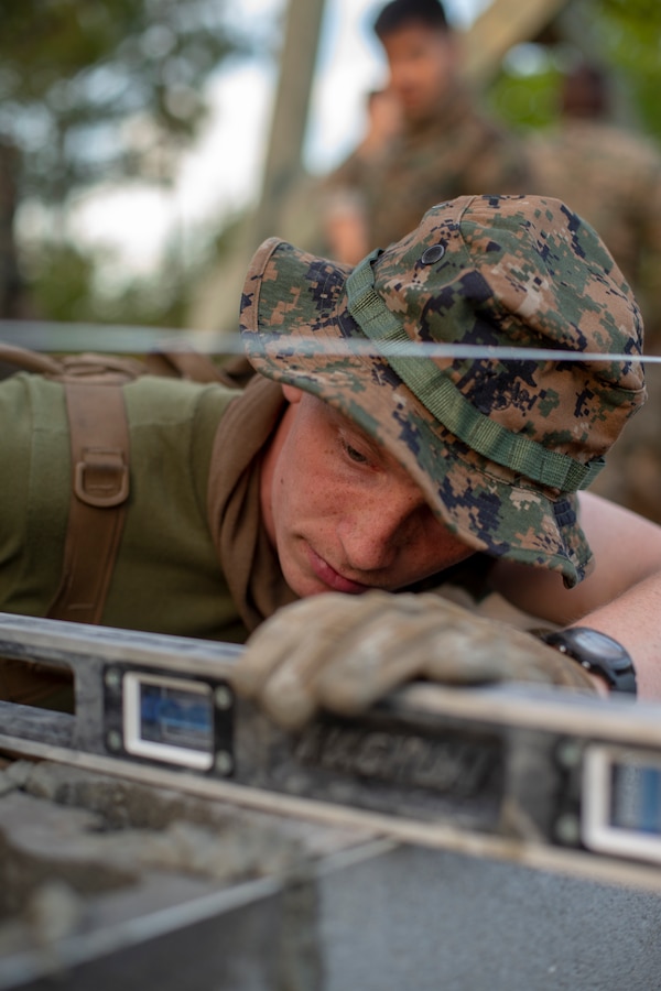 Lance Cpl. Joel Shewmaker, a combat engineer with Special Purpose Marine Air-Ground Task Force - Southern Command, checks the level of cylinder blocks during a general exercise at Marine Corps Base Camp Lejeune, North Carolina, April 13, 2020. The GENEX includes training events such as engineering projects and evacuation control center training scenarios that will help build the SPMAGTF-SC for their final certification exercise. These training events also provide the Marines and Sailors with real-world scenarios to prepare them for their deployment to assist partner nation militaries in Latin America and the Caribbean. Shewmaker is a native of Salem, Oregon. (U.S. Marine Corps photo by Cpl. Benjamin D. Larsen)