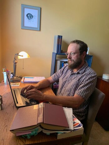 Josh Mayes, 628th Air Base Wing Historian, works on his laptop from home in Ladson, S.C., May 22, 2020. Some of Mayes’s day-to-day tasks consist of documenting current events and studying the past. Recently, Mayes has been documenting many events involving the COVID-19 pandemic.