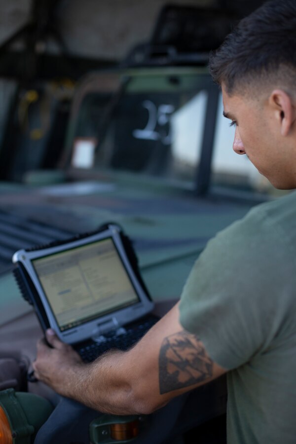 Lance Cpl. Anthony Ocken, a motor transport mechanic with Special Purpose Marine Air-Ground Task Force - Southern Command, researches components of a Humvee engine during a heavy equipment training exercise at Camp Lejeune, North Carolina, May 11, 2020. These training events assist the Marines and Sailors when working alongside partner nations in Latin America and the Caribbean with crisis response preparedness, security cooperation training, and engineering projects. Ocken is a native of Sacramento, California. (U.S. Marine Corps photo by Cpl. Benjamin D. Larsen)