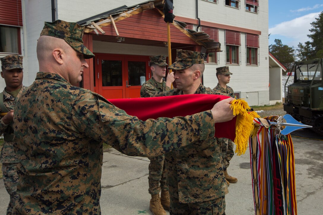 Lt. Col. L. Michael Stansberry, right, commanding officer of Marine Rotational Force – Europe 20.1, Marine Forces Europe and Africa, retires the battle streamers during the MRF-E 20.1 and 20.2 Transfer of Authority ceremony in Setermoen, Norway, May 27, 2020. MRF-E conducts various exercises, including arctic cold-weather and mountain-warfare training, as well as military-to-military engagements throughout Europe that enhance cooperation among partners and allies. (U.S. Marine Corps photo by Sgt. Abrey Liggins)