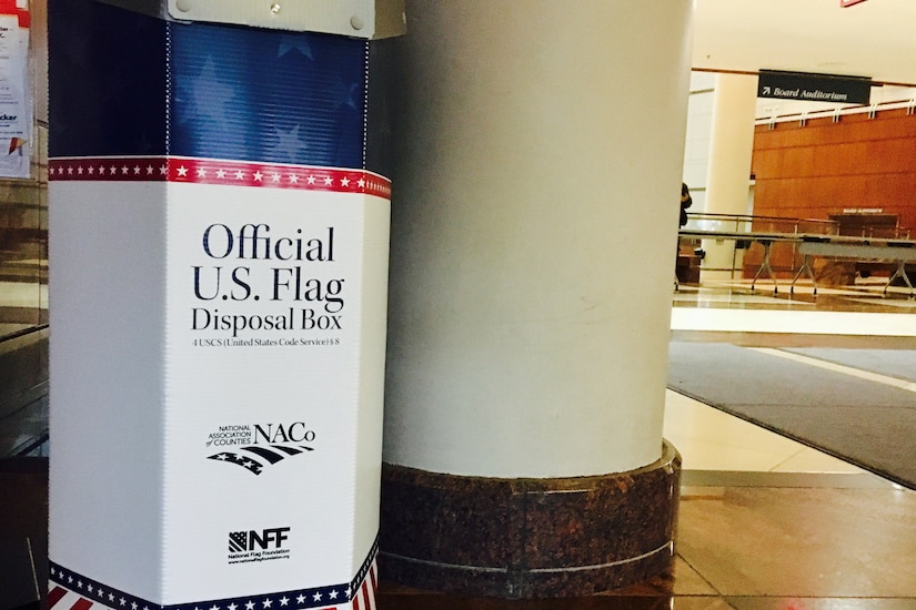 A large bin sits beside a column in a lobby.