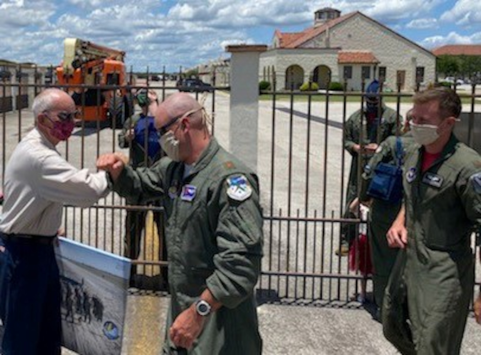 T-6 pilots assigned to the 340th Flying Training Group's 39th Flying Training Squadron and the 12th Flying Training Wing's 559th FTS bump elbows (the pandemic handshake) with retiring Joint Base San Antonio-Randolph, Texas T-6 maintainer Carl Powers, who retired May 31 after nearly 50 years of uniformed and civilian service. (U.S. Air Force photo)