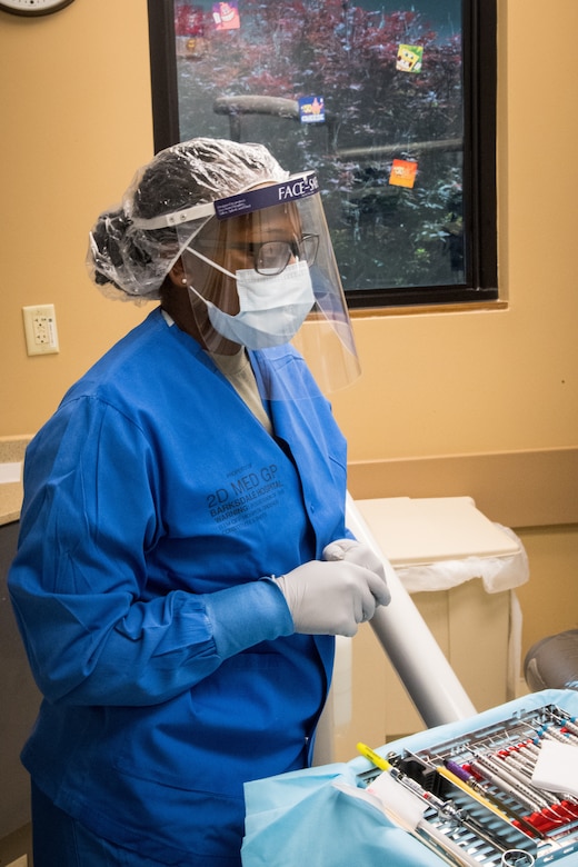 An Air Force dental technician examining a patient.