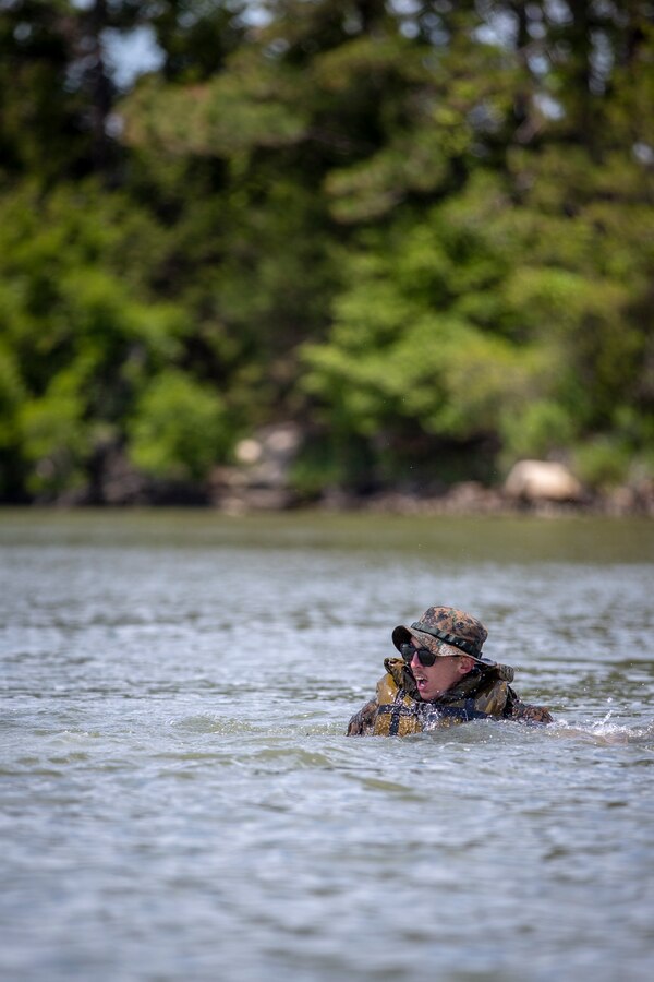 Sgt. Bill Pendergraft, a military policeman with Special Purpose Marine Air-Ground Task Force - Southern Command, shouts to his crew after going overboard during a training exercise at Camp Lejeune, North Carolina, May 12, 2020. The Marines train and learn small boat skills and procedures to better help the SPMAGTF-SC with mission accomplishment when deployed within jungle environments. These training events assist the Marines and Sailors when working alongside partner nations in Latin America and the Caribbean with crisis response preparedness, security cooperation training, and engineering projects. Pendergraft is a native of Pittsburgh, Pennsylvania. (U.S. Marine Corps photo by Cpl. Benjamin D. Larsen)