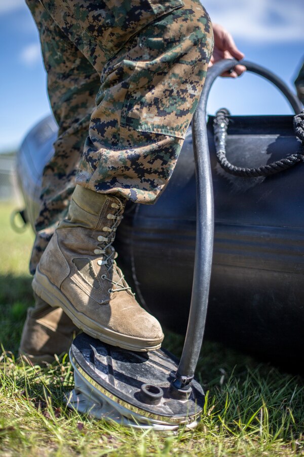 A Marine with Special Purpose Marine Air-Ground Task Force - Southern Command pumps a combat rubber riding craft with air during a training exercise at Camp Lejeune, North Carolina, May 12, 2020. The Marines train and learn small boat skills and procedures to better help the SPMAGTF-SC with mission accomplishment when deployed within jungle environments. These training events assist the Marines and Sailors when working alongside partner nations in Latin America and the Caribbean with crisis response preparedness, security cooperation training, and engineering projects. (U.S. Marine Corps photo by Cpl. Benjamin D. Larsen)