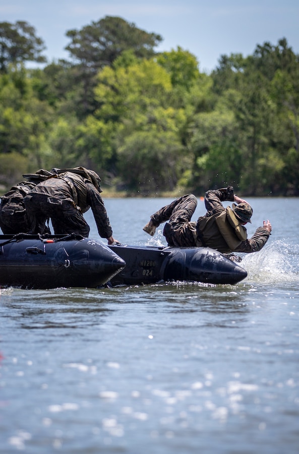 A Marine with Special Purpose Marine Air-Ground Task Force - Southern Command bails out of a combat rubber raiding craft for a broaching drill during a training exercise at Camp Lejeune, North Carolina, May 12, 2020. The Marines train and learn small boat skills and procedures to better help the SPMAGTF-SC with mission accomplishment when deployed within jungle environments. These training events assist the Marines and Sailors when working alongside partner nations in Latin America and the Caribbean with crisis response preparedness, security cooperation training, and engineering projects. (U.S. Marine Corps photo by Cpl. Benjamin D. Larsen)