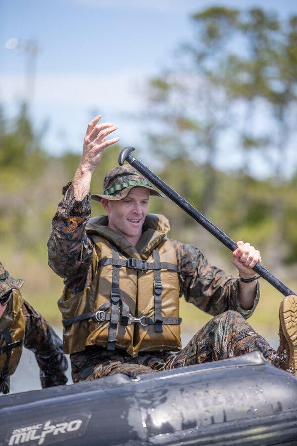 Maj. Drew Miller, a military police officer with Special Purpose Marine Air-Ground Task Force - Southern Command, adjusts himself to race another team in a combat rubber raiding craft circuit course during a training exercise at Camp Lejeune, North Carolina, May 12, 2020. The Marines train and learn small boat skills and procedures to better help the SPMAGTF-SC with mission accomplishment when deployed within jungle environments. These training events assist the Marines and Sailors when working alongside partner nations in Latin America and the Caribbean with crisis response preparedness, security cooperation training, and engineering projects. Miller is a native of Nashville, Tennessee. (U.S. Marine Corps photo by Cpl. Benjamin D. Larsen)