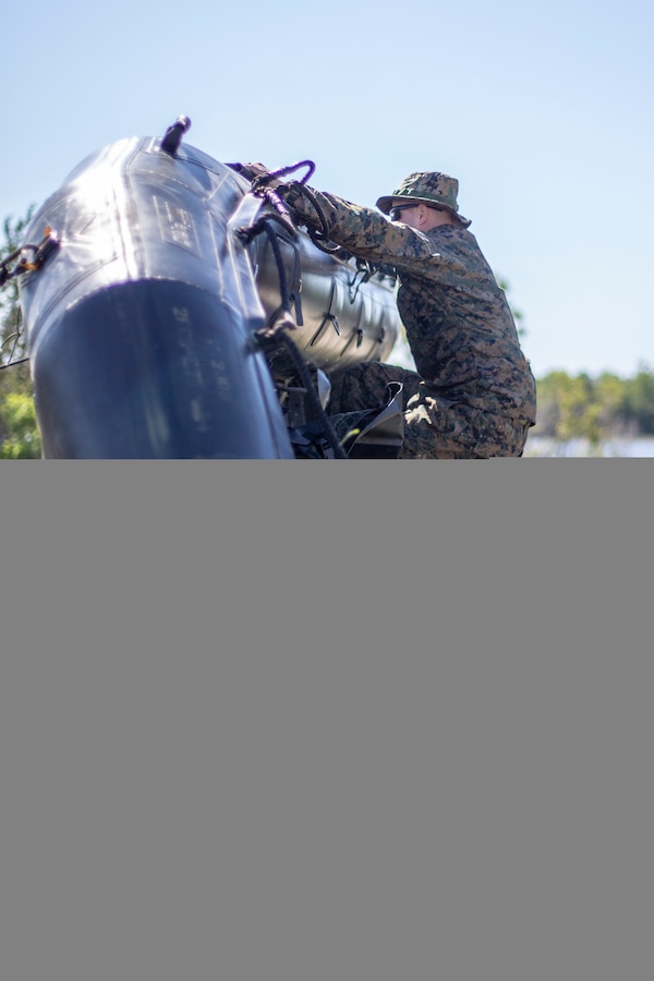 Capt. Daniel Kent, a military police officer with Special Purpose Marine Air-Ground Task Force - Southern Command, practices small boat flipping techniques during a training exercise at Camp Lejeune, North Carolina, May 12, 2020. The Marines train and learn small boat skills and procedures to better help the SPMAGTF-SC with mission accomplishment when deployed within jungle environments. These training events assist the Marines and Sailors when working alongside partner nations in Latin America and the Caribbean with crisis response preparedness, security cooperation training, and engineering projects. Kent is a native of Baltimore, Maryland. (U.S. Marine Corps photo by Cpl. Benjamin D. Larsen)