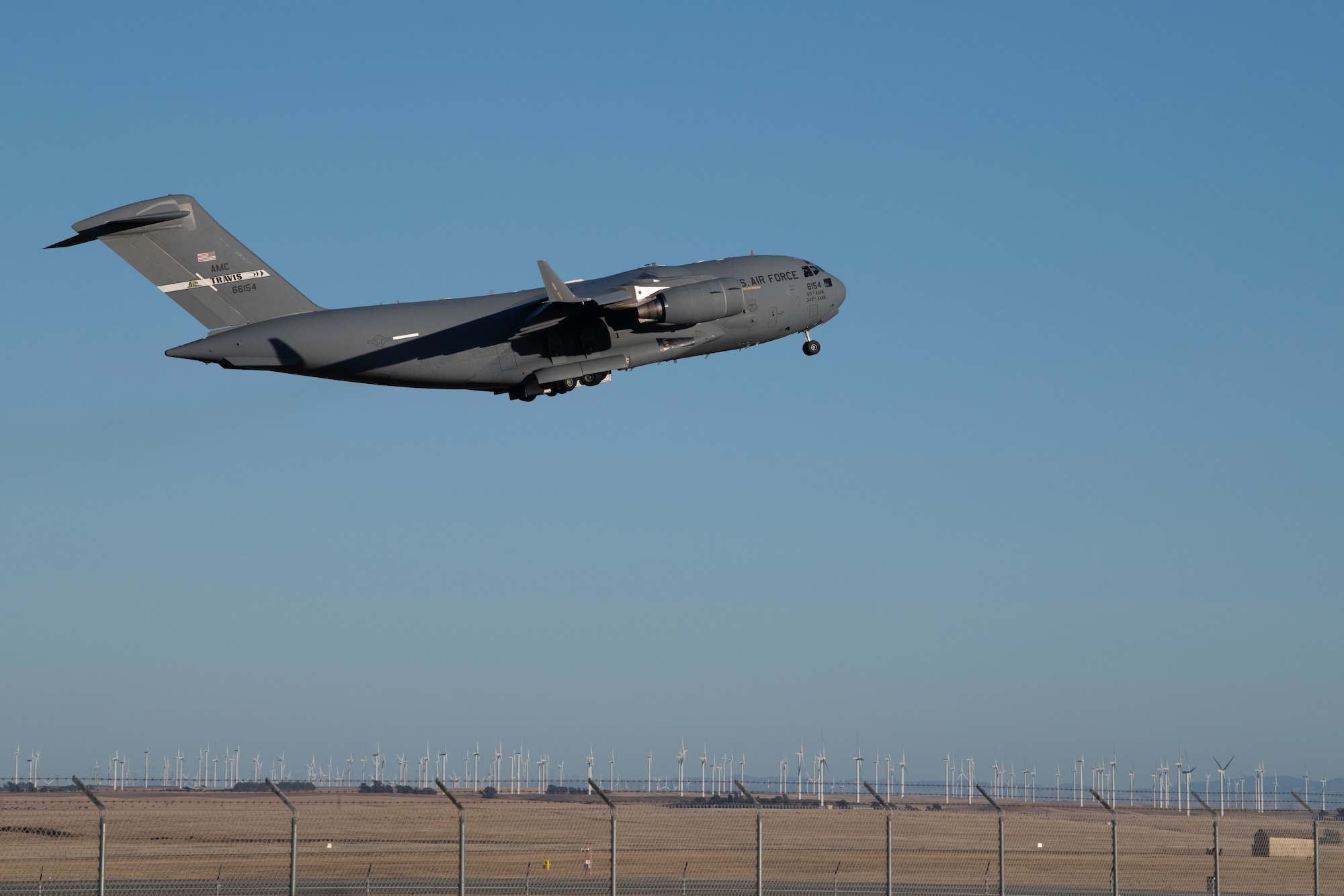 A C-17 Globemaster III takes off from the runway at Travis Air Force Base, California, May 27, 2020. The C-17 can take off and land on runways as short as 3,500 feet and only 90 feet wide. (U.S. Air Force photo by Tech. Sgt. James Hodgman)