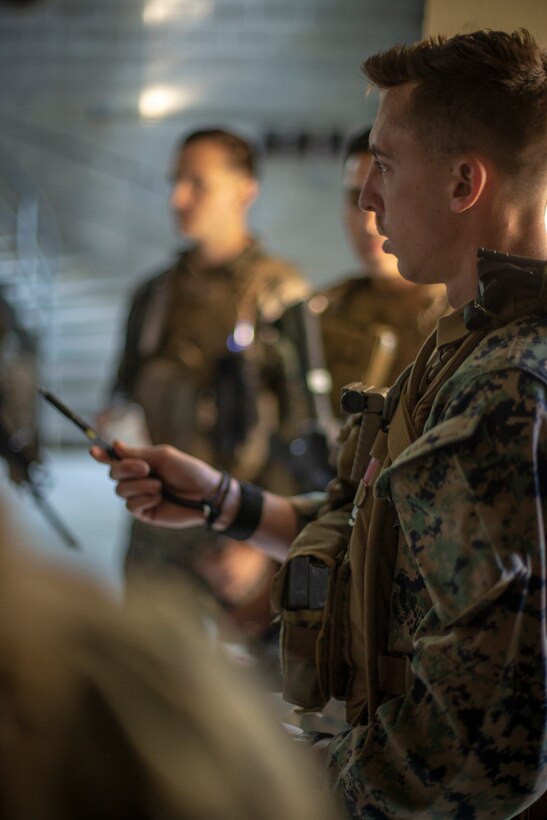 Sgt. Bill Pendergraft, a military policeman with Special Purpose Marine Air-Ground Task Force - Southern Command, briefs his squad about an upcoming mock raid during a field exercise at Camp Lejeune, North Carolina, May 7, 2020. The Marines train and perform a variety of infantry skill evaluations during the field exercise to help sharpen their overall capabilities. These training events assist the Marines and Sailors when working alongside partner nations in Latin America and the Caribbean with crisis response preparedness, security cooperation training, and engineering projects. Pendergraft is a native of Pittsburgh, Pennsylvania. (U.S. Marine Corps photo by Cpl. Benjamin D. Larsen)