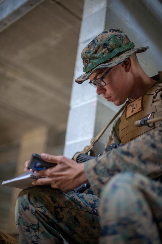Cpl. Olav Wampler, a field radio operator with Special Purpose Marine Air-Ground Task Force - Southern Command, confirms radio frequencies during a field exercise at Camp Lejeune, North Carolina, May 7, 2020. The Marines train and perform a variety of infantry skill evaluations during the field exercise to help sharpen their overall capabilities. These training events assist the Marines and Sailors when working alongside partner nations in Latin America and the Caribbean with crisis response preparedness, security cooperation training, and engineering projects. Wampler is a native of Bothell, Washington. (U.S. Marine Corps photo by Cpl. Benjamin D. Larsen)