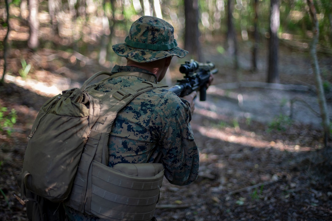 Cpl. Olav Wampler, a field radio operator with Special Purpose Marine Air-Ground Task Force - Southern Command, posts security during a field exercise at Camp Lejeune, North Carolina, May 7, 2020. The Marines train and perform a variety of infantry skill evaluations during the field exercise to help sharpen their overall capabilities. These training events assist the Marines and Sailors when working alongside partner nations in Latin America and the Caribbean with crisis response preparedness, security cooperation training, and engineering projects. Wampler is a native of Bothell, Washington. (U.S. Marine Corps photo by Cpl. Benjamin D. Larsen)