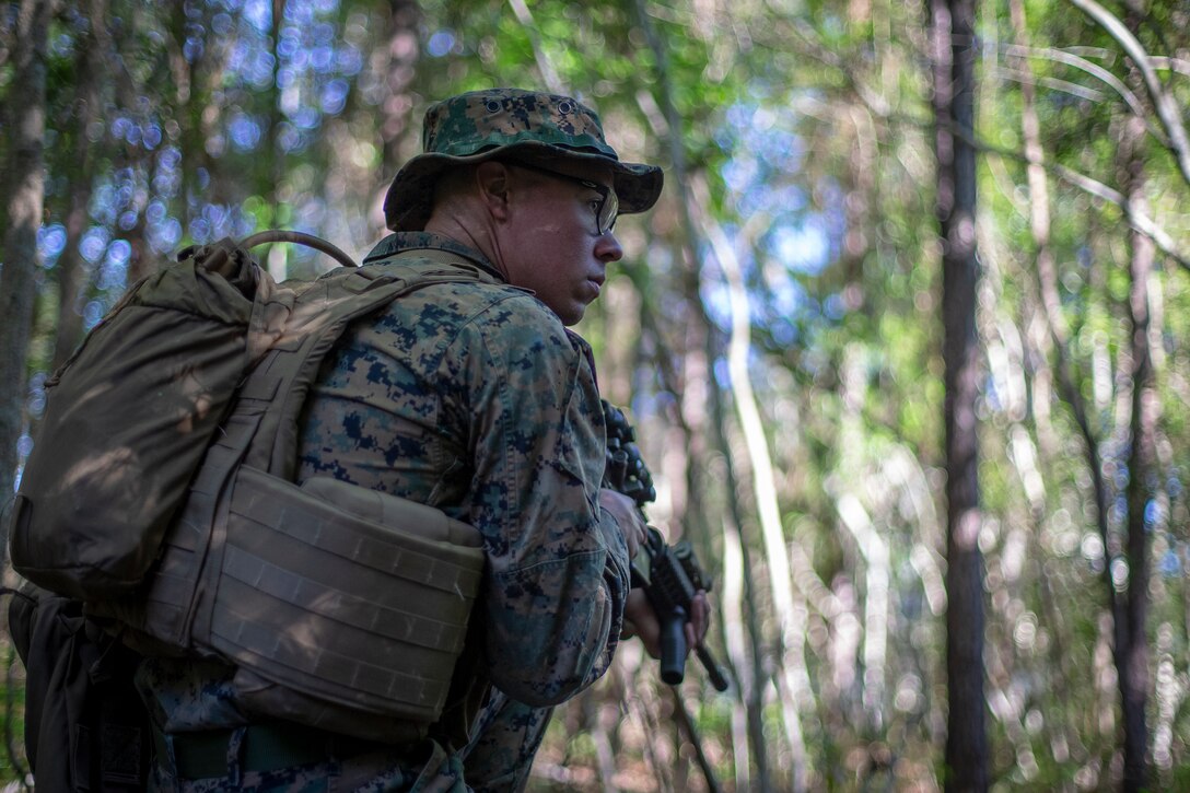 Cpl. Olav Wampler, a field radio operator with Special Purpose Marine Air-Ground Task Force - Southern Command, posts security during a field exercise at Camp Lejeune, North Carolina, May 7, 2020. The Marines train and perform a variety of infantry skill evaluations during the field exercise to help sharpen their overall capabilities. These training events assist the Marines and Sailors when working alongside partner nations in Latin America and the Caribbean with crisis response preparedness, security cooperation training, and engineering projects.  Wampler is a native of Bothell, Washington. (U.S. Marine Corps photo by Cpl. Benjamin D. Larsen)