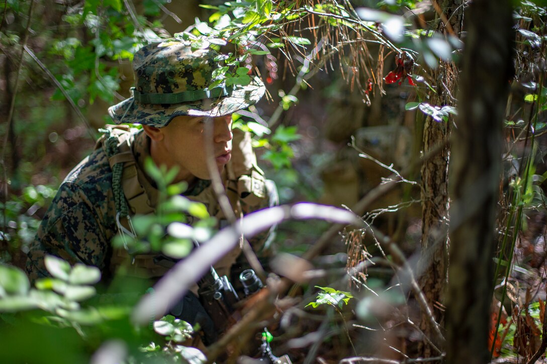 Staff Sgt. Ramon Perez, a criminal investigator with Special Purpose Marine Air-Ground Task Force - Southern Command, commands his squad during a field exercise at Camp Lejeune, North Carolina, May 7, 2020. The Marines train and perform a variety of infantry skill evaluations during the field exercise to help sharpen their overall capabilities. These training events assist the Marines and Sailors when working alongside partner nations in Latin America and the Caribbean with crisis response preparedness, security cooperation training, and engineering projects. Perez is a native of Newark, New Jersey. (U.S. Marine Corps photo by Cpl. Benjamin D. Larsen)