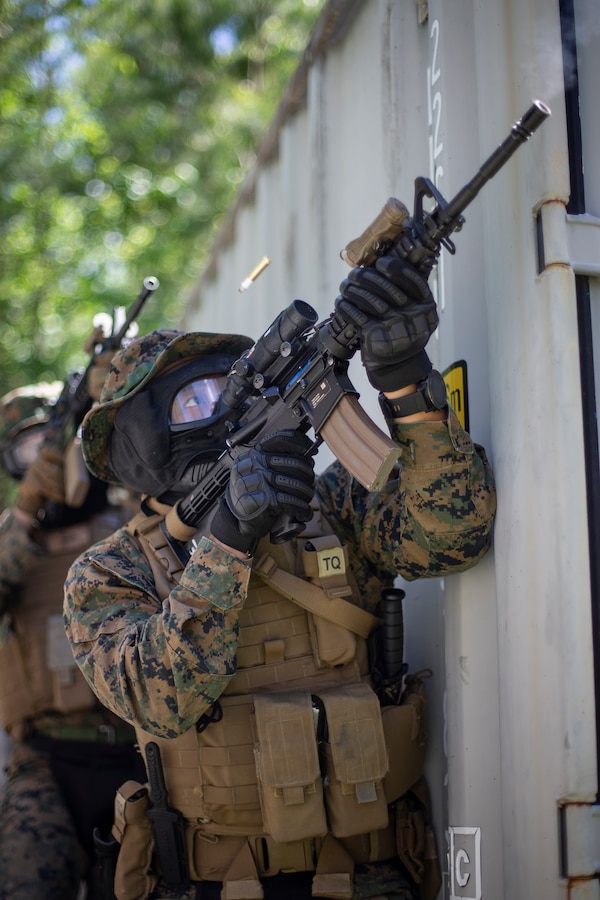 Staff Sgt. Steven Amnatkeolee, a military policeman with Special Purpose Marine Air-Ground Task Force - Southern Command, returns fire using simulated ammunition, or paint rounds, on a compound during a field exercise at Camp Lejeune, North Carolina, May 7, 2020. The Marines train and perform a variety of infantry skill evaluations during the field exercise to help sharpen their overall capabilities. These training events assist the Marines and Sailors when working alongside partner nations in Latin America and the Caribbean with crisis response preparedness, security cooperation training, and engineering projects. Amnatkeolee is a native of Anchorage, Alaska. (U.S. Marine Corps photo by Cpl. Benjamin D. Larsen)