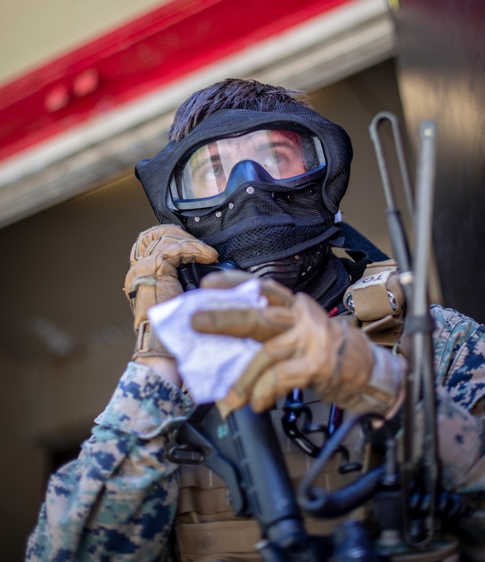 Sgt. Jose Labra Escudero, a field radio operator with Special Purpose Marine Air-Ground Task Force - Southern Command, calls in a medical evacuation amidst a mock raid over the radio during a field exercise at Camp Lejeune, North Carolina, May 7, 2020. The Marines train and perform a variety of infantry skill evaluations during the field exercise to help sharpen their overall capabilities. These training events assist the Marines and Sailors when working alongside partner nations in Latin America and the Caribbean with crisis response preparedness, security cooperation training, and engineering projects. Labra Escudero is a native of Greensboro, North Carolina. (U.S. Marine Corps photo by Cpl. Benjamin D. Larsen)
