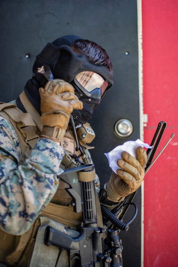 Sgt. Jose Labra Escudero, a field radio operator with Special Purpose Marine Air-Ground Task Force - Southern Command, calls in a medical evacuation amidst a mock raid over the radio during a field exercise at Camp Lejeune, North Carolina, May 7, 2020. The Marines train and perform a variety of infantry skill evaluations during the field exercise to help sharpen their overall capabilities. These training events assist the Marines and Sailors when working alongside partner nations in Latin America and the Caribbean with crisis response preparedness, security cooperation training, and engineering projects. Labra Escudero is a native of Greensboro, North Carolina. (U.S. Marine Corps photo by Cpl. Benjamin D. Larsen)