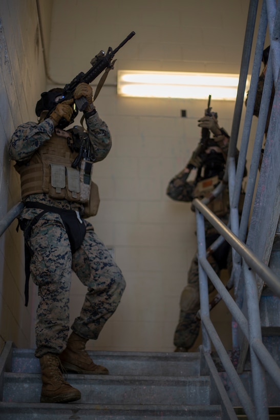 Marines with Special Purpose Marine Air-Ground Task Force - Southern Command ensure a stairwell is clear of enemy threats during a field exercise at Camp Lejeune, North Carolina, May 7, 2020. The Marines train and perform a variety of infantry skill evaluations during the field exercise to help sharpen their overall capabilities. These training events assist the Marines and Sailors when working alongside partner nations in Latin America and the Caribbean with crisis response preparedness, security cooperation training, and engineering projects. (U.S. Marine Corps photo by Cpl. Benjamin D. Larsen)