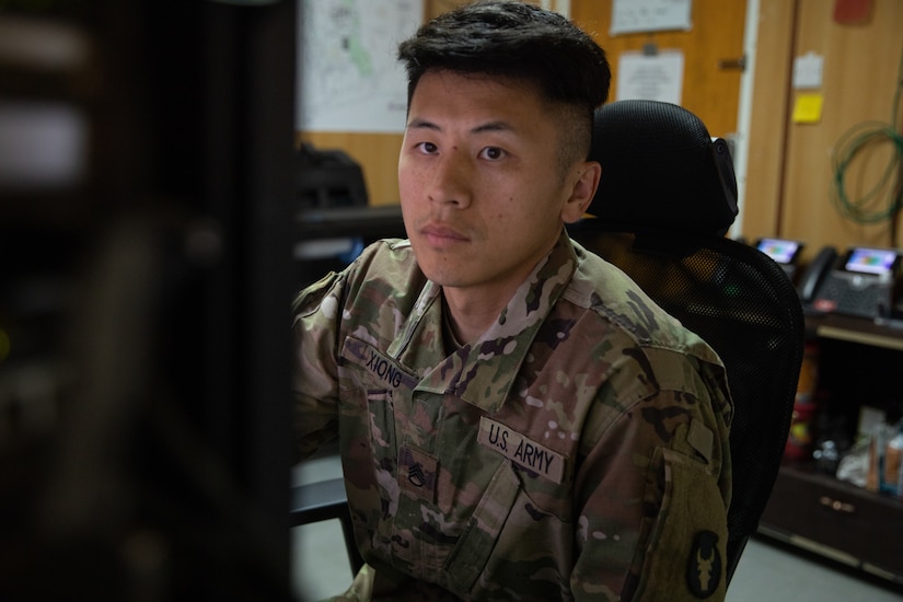 Staff Sgt. Nhia Xiong prepares to print a tactical map in his office while he is deployed to the Middle East with the Headquarters & Headquarters Company, 34th Expeditionary Combat Aviation Brigade. His role as the geospatial non-commissioned officer in charge is to oversee the creation and printing of maps used by other units in his area of operations for missions that support of Operation Spartan Shield and Operation Inherent Resolve.