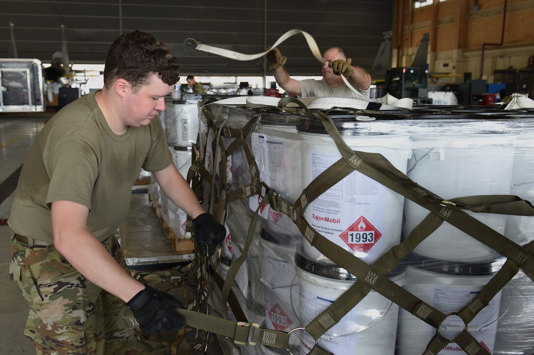Photo of Airman securing a pallet