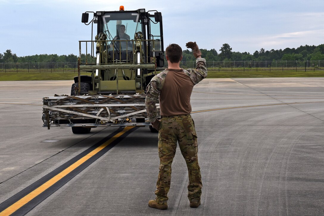 Photo of Airman guiding a forklift