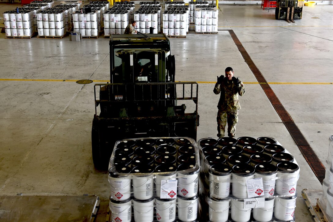 Photo of Airman guiding a forklift