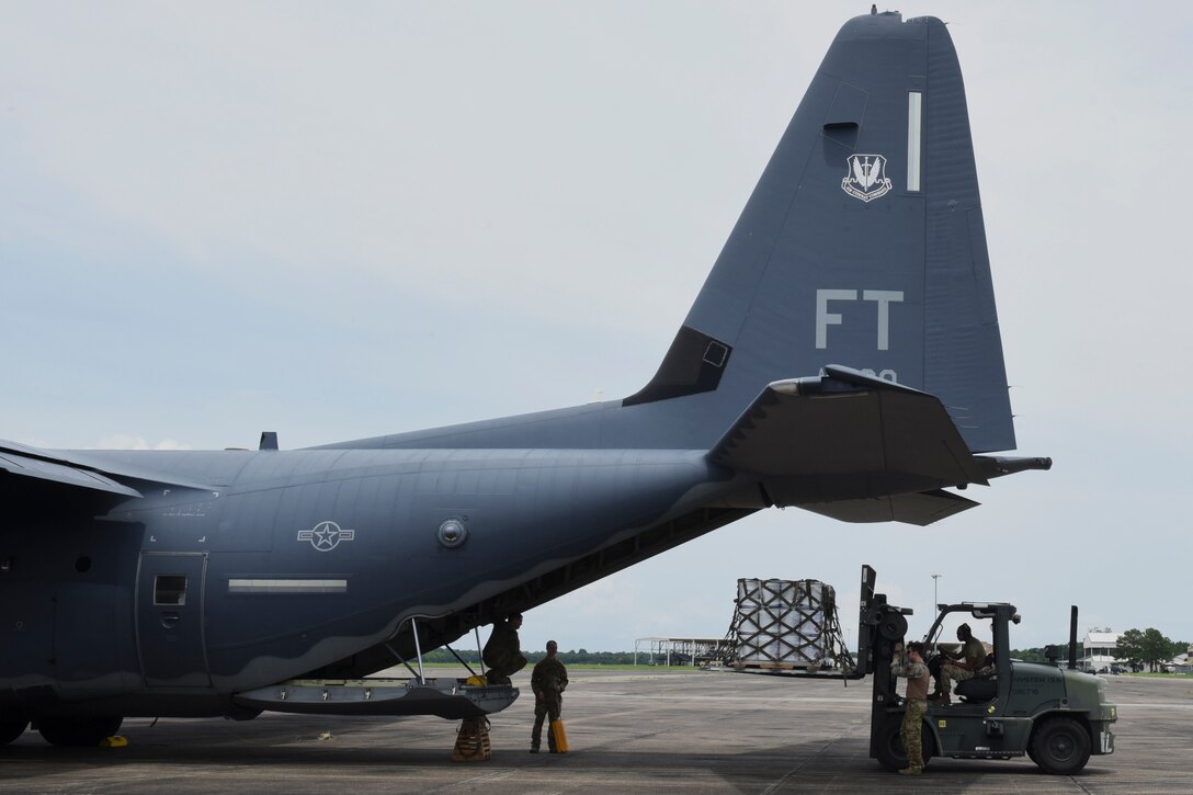 Photo of Airman loading a pallet into an aircraft