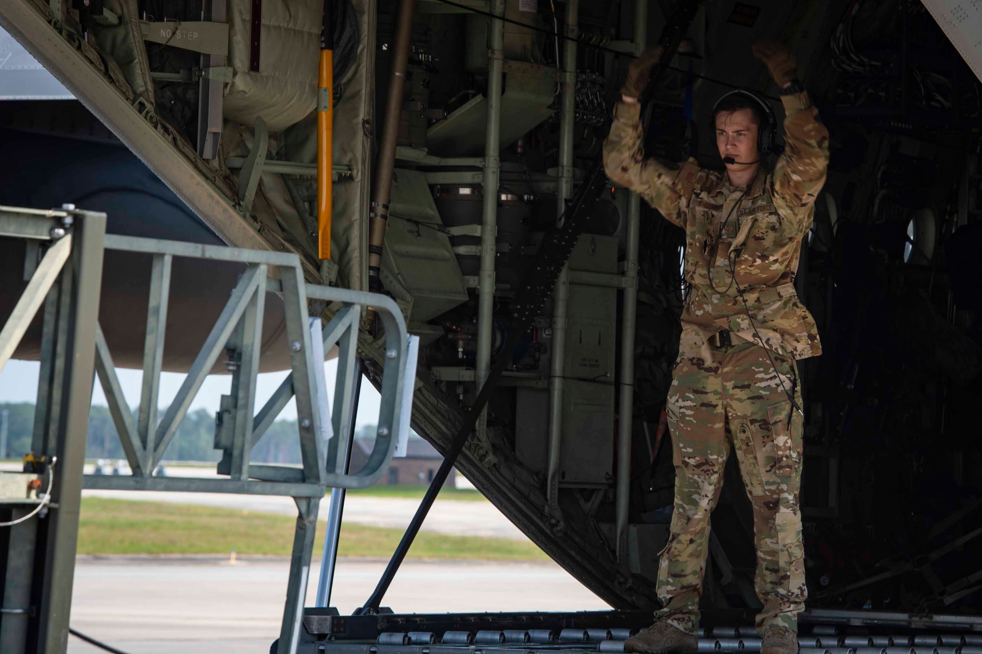 Photo of Airman guiding a pay-loader