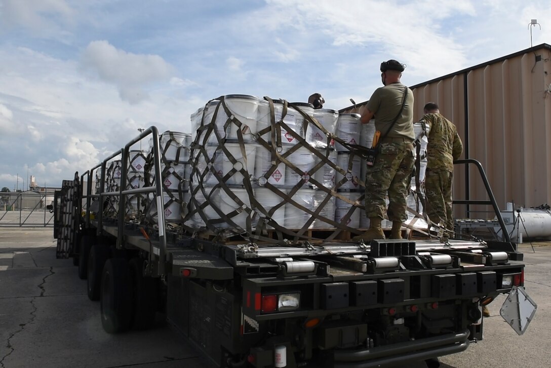 Photo of Airman removing net sets from hand sanitizer pallets