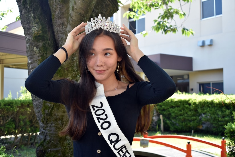 Student puts on her prom queen crown.