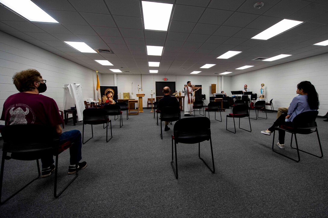 Photo of Moody Airmen and families attending Catholic service.
