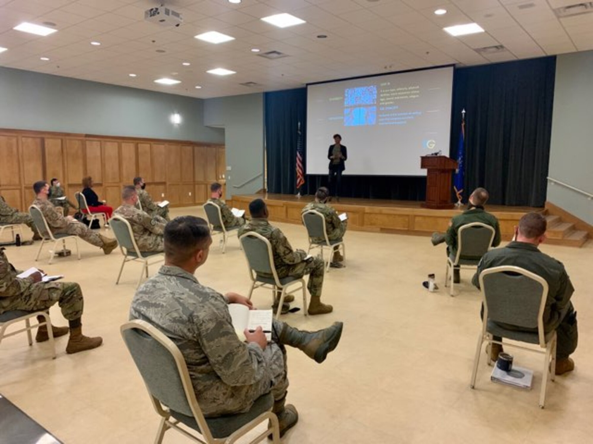 A woman stand in front of a room of command teams