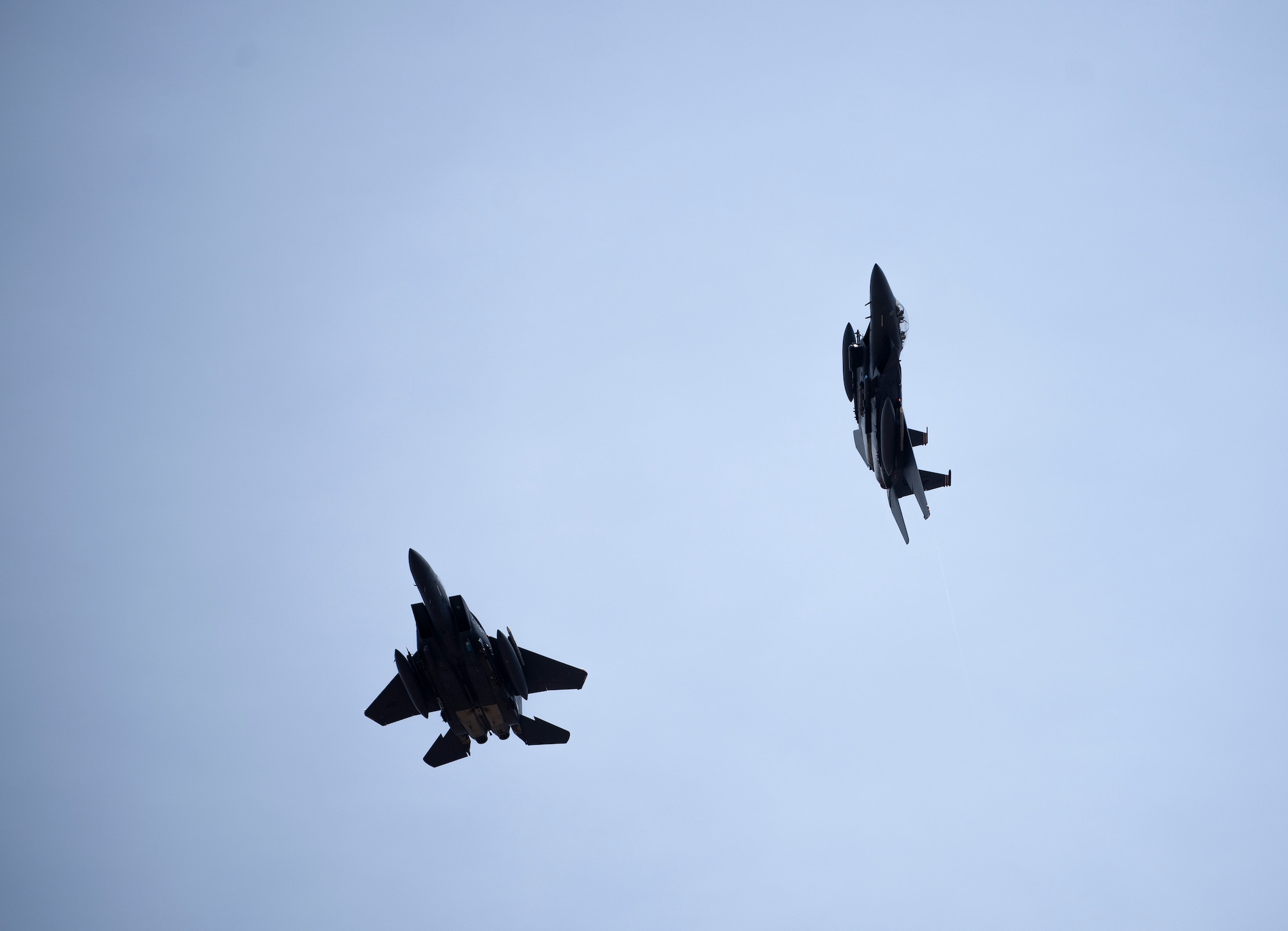 Two F-15E Strike Eagles assigned to the 494th Fighter Squadron fly over Royal Air Force Lakenheath, England, June 2, 2020. Despite the current COVID-19 crisis, the 48th Fighter Wing continues to maintain combat readiness in order to safeguard U.S. national interests and those of the NATO alliance. (U.S. Air Force photo by Airman 1st Class Jessi Monte)