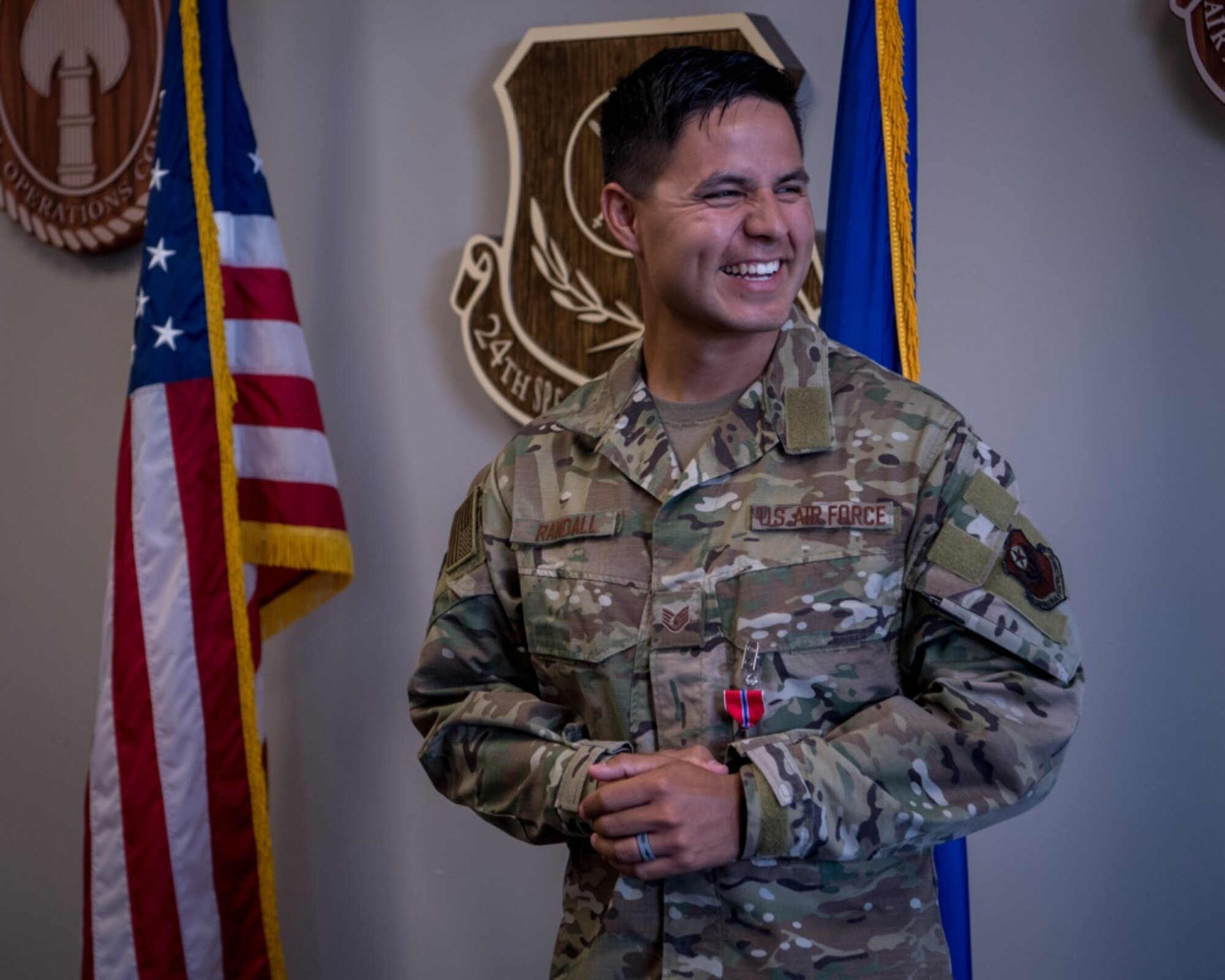 An airman smiles after receiving an award